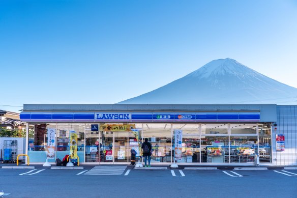 A Lawson convenience store   with Mount Fuji successful  the background.