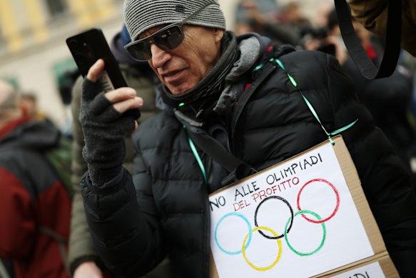 A protester objects to the costs of staging the Winter Olympics in Milan.