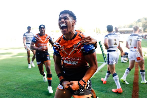 Tigers winger Luke Laulilii scores against the Cowboys.