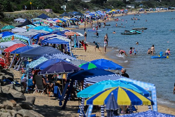 Cabanas and beachgoers at Safety Beach on the Mornington Peninsula.