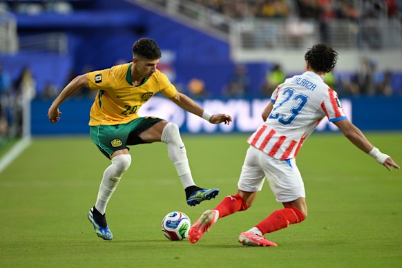 Australia’s Cristian Volpato looks to get past Paraguay’s Matias Galarza.