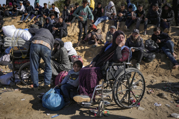 Displaced Palestinians wait near a roadblock after being stopped from returning to northern Gaza.