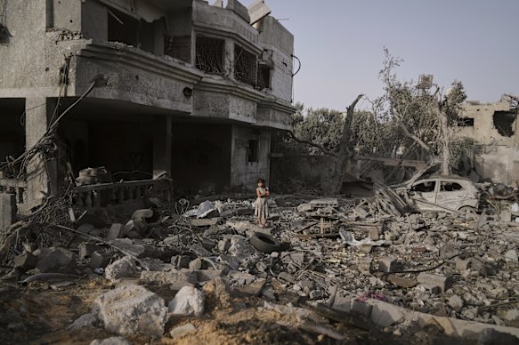 A Palestinian girl stands atop the rubble of the Al-Aimawi family’s home that was destroyed by Israeli airstrikes in the Gaza Strip on Tuesday.