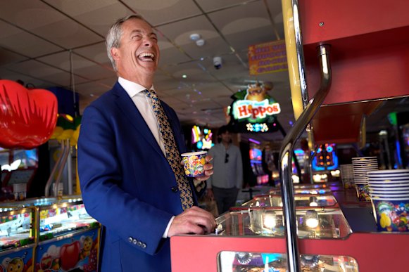 Farage, playing a game in an amusement arcade in Clacton-On-Sea in June, faces two parliamentary inquiries into financial support he has received from mysterious donors.