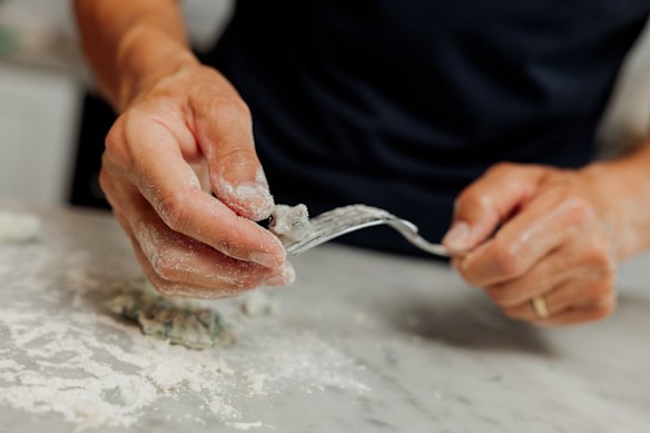 Rolling the dough over a fork creates ridges that help the gnocchetti hold on to the sauce.