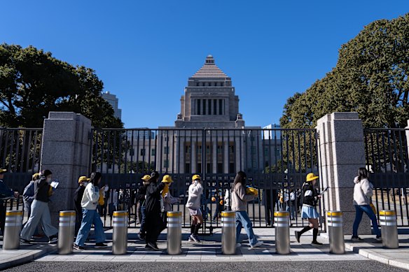 Students walk past the National Diet building on Friday.