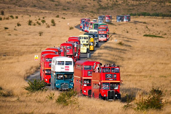 A parade of buses leaves the abandoned village of Imber on the Ministry of Defence training area in Salisbury Plain in Imber, England.