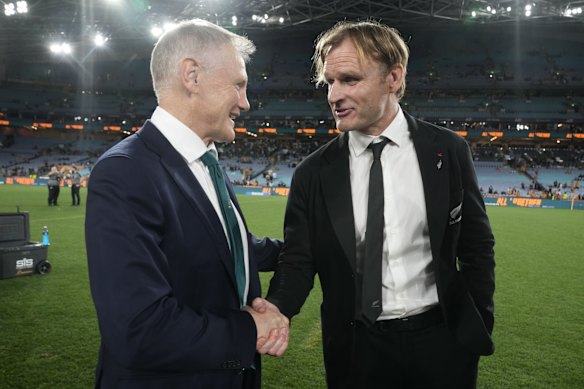 Former New Zealand coach Scott Robertson shakes hands with Australia coach Joe Schmidt.