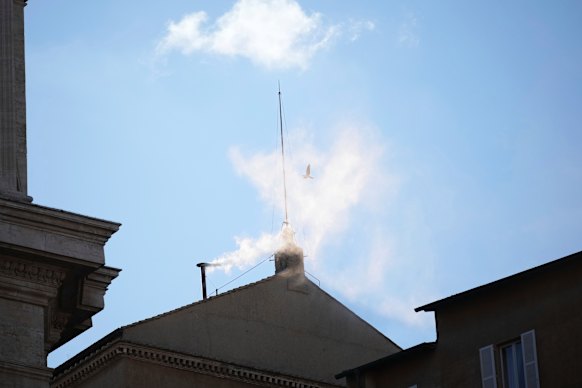 White smoke billows from the chimney of the Sistine Chapel during the conclave to elect a new pope.