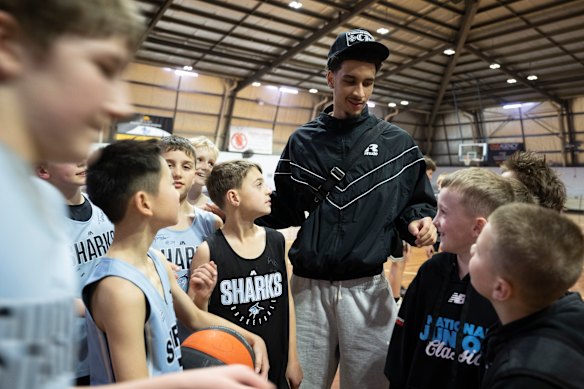 Aussie basketballer Tyrese Proctor mixes with juniors at his old club Sutherland Sharks.