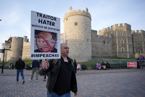 A protester holds a placard in front of Windsor Castle.