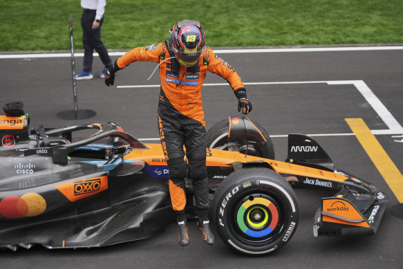 Piastri jumps from his car after his win.