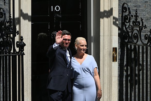 Burnham and his wife, Marie-France van Heel, wave as they enter 10 Downing Street.
