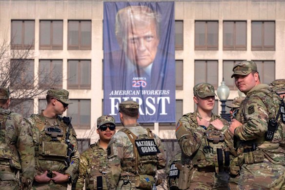 National Guard members gather near a large portrait of President Donald Trump on the Labor Department headquarters in Washington, in January.