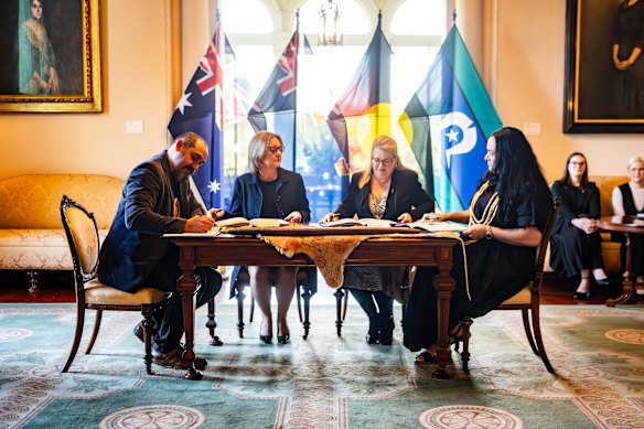  First Peoples’ Assembly co-chair Rueben Berg, Premier Jacinta Allan, Minister for Treaty Natalie Hutchinson and assembly co-chair Ngarra Murray sign Victoria’s statewide treaty at Government House.