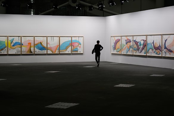 A visitor looks at the artwork by Jorinde Voigt "Song of the Earth – ‘The Shift’ and ‘Divine Territory’", 2016 during a press preview of the 2026 Art Basel at Messe Basel.