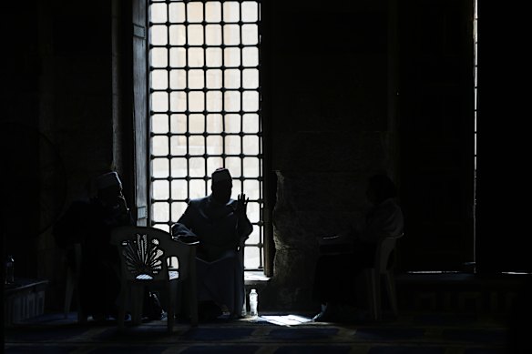 A Shiekh speaks to visitors at the Sultan Ashraf Qaytbay Mosque, built between 1472 and 1474 AD, and considered a masterpiece of late Mamluk architecture, in Cairo, Egypt.