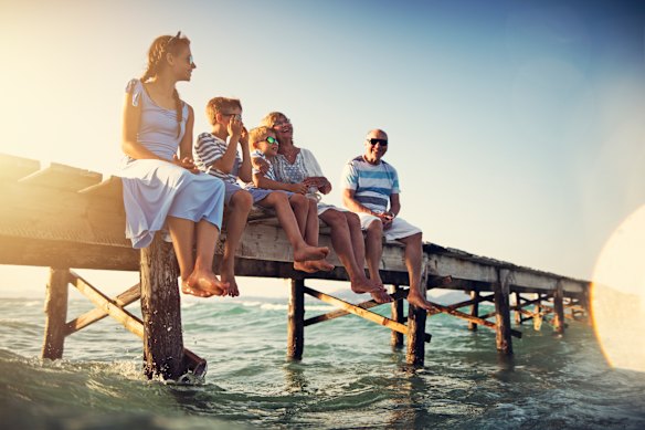 Grandparents and grandkids sitting on a wharf