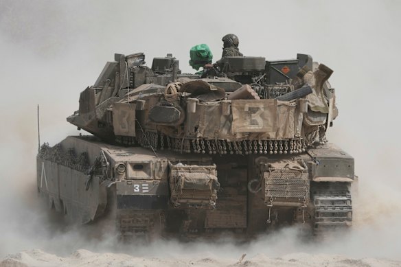Israeli soldiers move tanks near the border with the Gaza Strip, in southern Israel, on Sunday