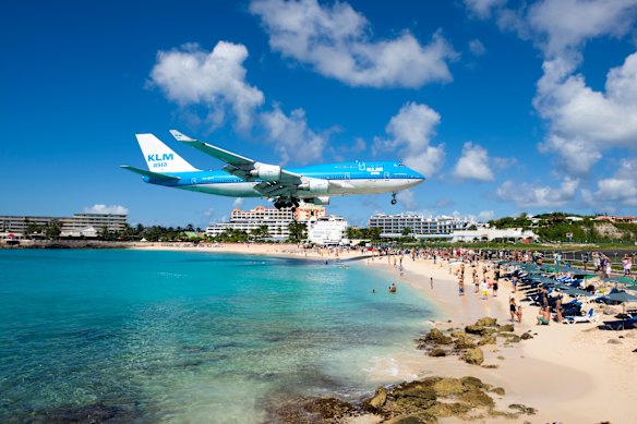 Beachgoers watch as KLM Boeing 747 comes in for a landing at Princess Juliana International Airport in Sint Maarten.