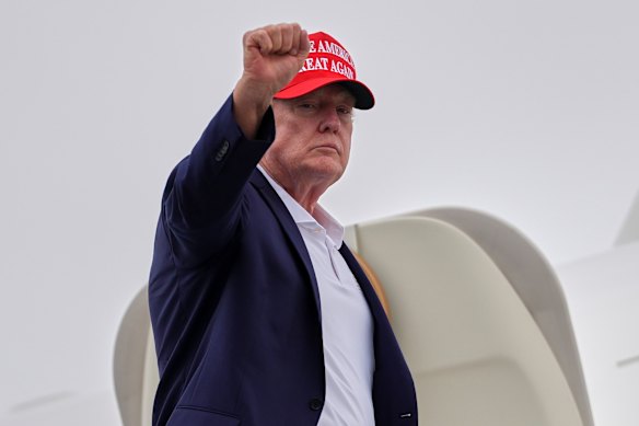 President Donald Trump gestures as he boards Air Force One on Sunday.