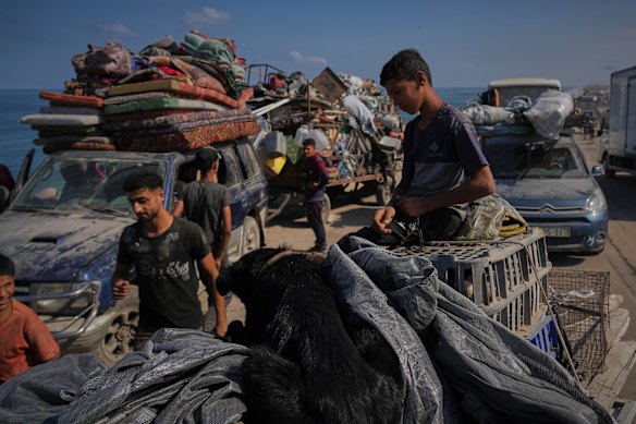 Displaced Palestinians carry their belongings as they flee northern Gaza.