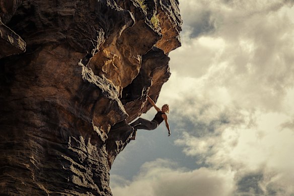 Charlize Theron hangs off the side of a cliff in the Australian-shot thriller Apex.