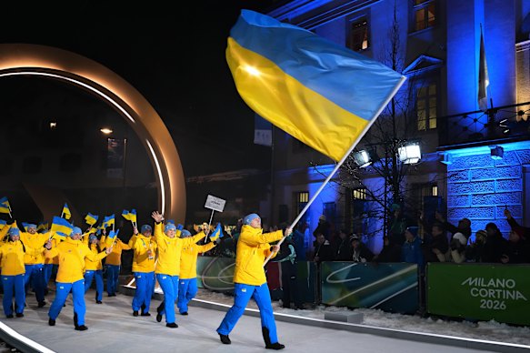 Vladyslav Heraskevych carries the flag for Ukraine in the opening ceremony.
