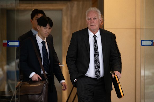 Former AFL umpires’ coach Frank Kalayzich (right) departing a Fair Work Commission hearing in 2025.