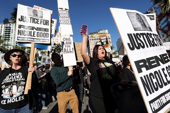 Protesters at a rally for Renee Good, calling for an end to federal immigration enforcement and military action in Venezuela in Los Angeles on Sunday AEDT.