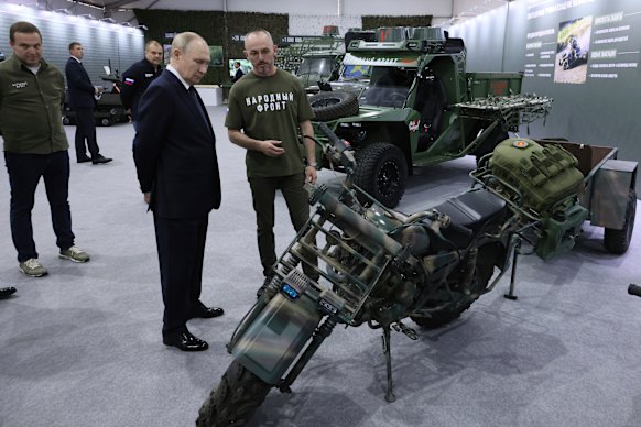 Russian President Vladimir Putin, center left, visits an exhibition of the All-Russian People’s Front called “All for victory!” in Moscow. 