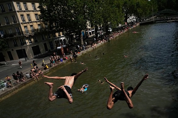 Parisians bathe in the Canal Saint-Martin in Paris, as the national weather service, Meteo France, placed 54 departments, about half the country, under a red heat wave alert.