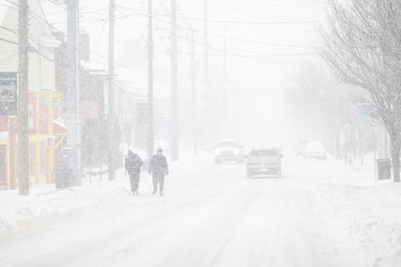 People walk the streets in near whiteout conditions in Louisville, Kentucky.