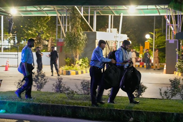 Police officers arrive to take position outside the Shifa International Hospital on August 20, where imprisoned former Prime Minister Imran Khan was meant to have a medical examination. 