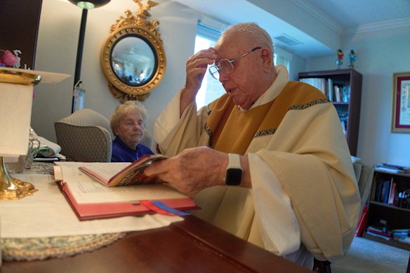The Reverend James Kelly celebrates Mass at his apartment in the retirement community.
