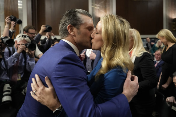 Pete Hegseth kisses his wife Jennifer Rauche at the completion of a Senate Armed Services Committee hearing for his confirmation.