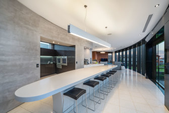 Curved walls, floor-to-ceiling windows and a kitchen with butler's pantry.