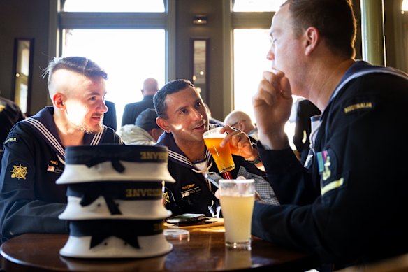 Servicemen take a break after the Anzac Day march and dawn service in Melbourne.