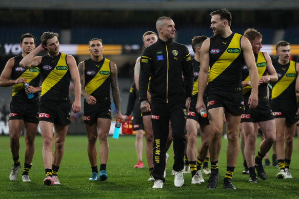 Injured Dustin Martin leaves the tract  with Noah Balta and their Richmond teammates.
