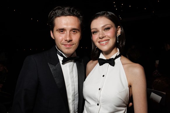 Brooklyn Beckham, left, and Nicola Peltz attend the Victoria Beckham Spring/Summer 2025 collection presented in Paris in September, 2024, before the family fractures.