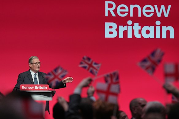 Flags fly as Starmer speaks.