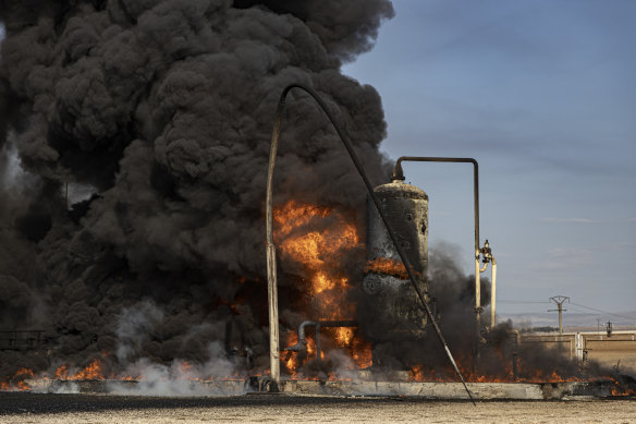 A smoke rises from an oil depot struck by Turkish air force near the town of Qamishli, Syria. 