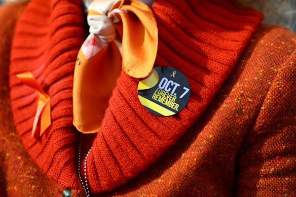 An attendee wears a sticker to remember October 7.