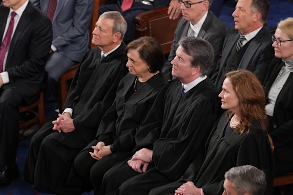 Four of the nine US Supreme Court judges sit impassively as Trump expresses his frustration at their decision on tariffs.