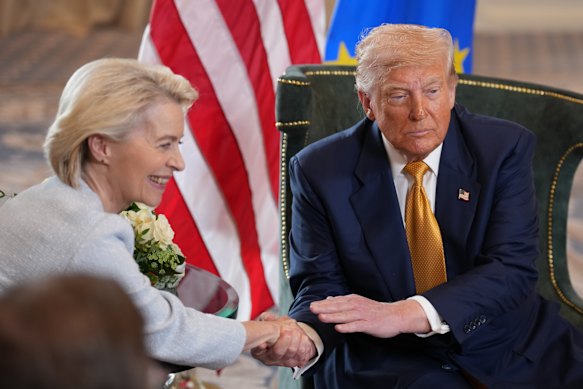 European Commission president Ursula von der Leyen and US President Donald Trump shake hands on a new deal.  