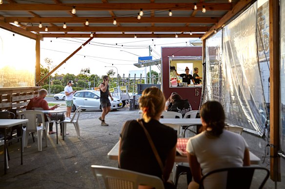 Beside a cheap petrol station, diners sit on plastic chairs at foldable tables to enjoy Papi’s Birria Tacos with a view of Parramatta Road. 