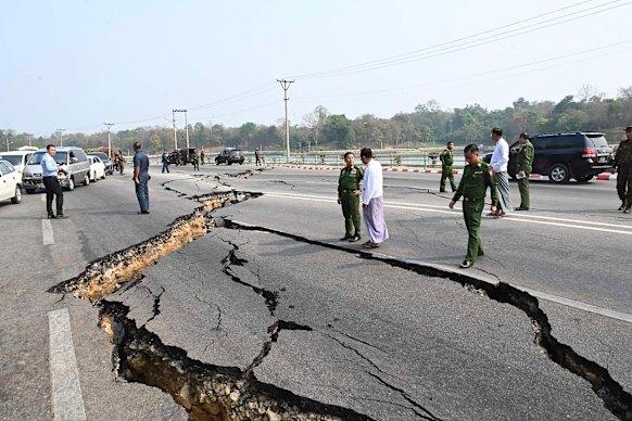 Myanmar’s military leader Senior General Min Aung Hlaing, centre in green, inspects a damaged road in Naypyitaw.