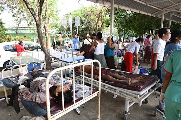 Earthquake victims and family members gather at the government hospital compound in Naypyitaw.
