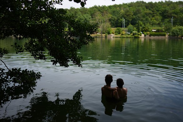 A woman and her child swim in the Seine river, in Samois-sur-Seine, south of Paris.