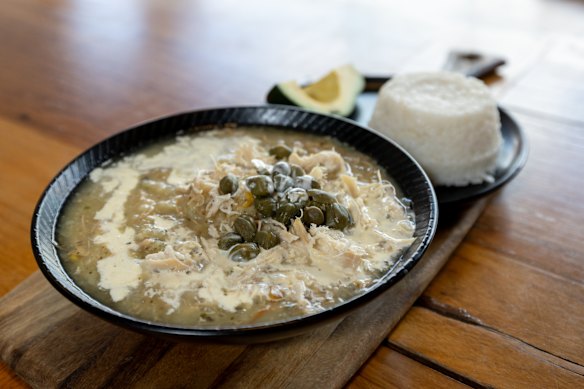 Ajiaco santafereno, a chicken soup from Bogota, made with three different types of potatoes (red, white and yellow) that collapse into sturdy starch, plus guascas, a grassy herb, then garnished with cream and capers.